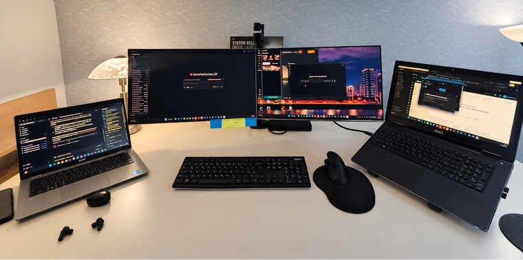 Arbeitsplatz für Online-Unterricht mit Monitor, Laptop und Schreibtischlampe